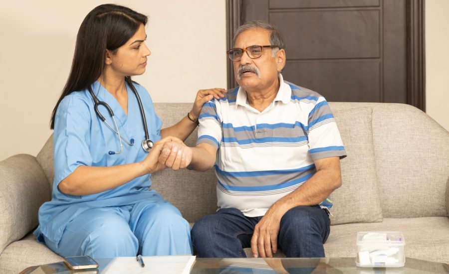Cheerful,Indian,Female,General,Practitioner,Communicating,With,Pleasant,60s,Male